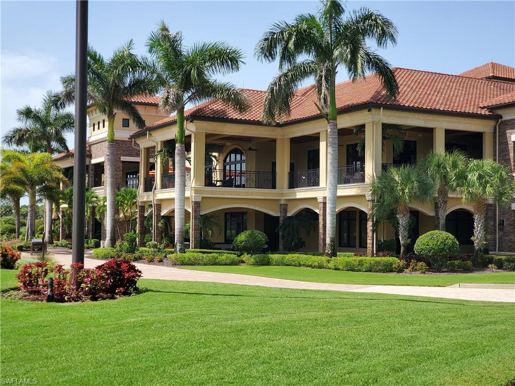 9521 Avellino Way, Unit 2415 Naples, FL 34113 - Photo 14 of 48 a front view of multiple houses with yard and green space