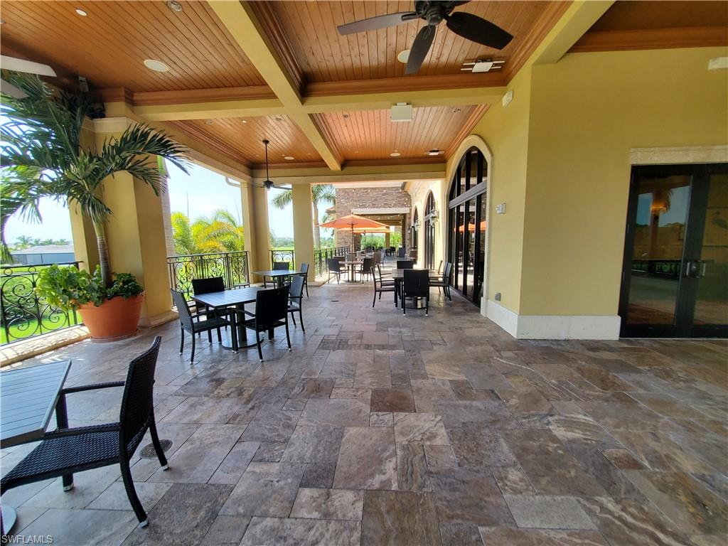 9521 Avellino Way, Unit 2415 Naples, FL 34113 - Photo 16 of 48 a view of a porch with table and chairs
