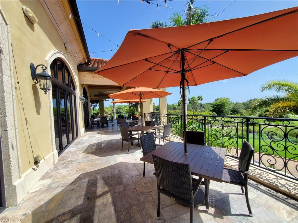 9521 Avellino Way, Unit 2415 Naples, FL 34113 - Photo 17 of 48 a view of chairs and tables in patio