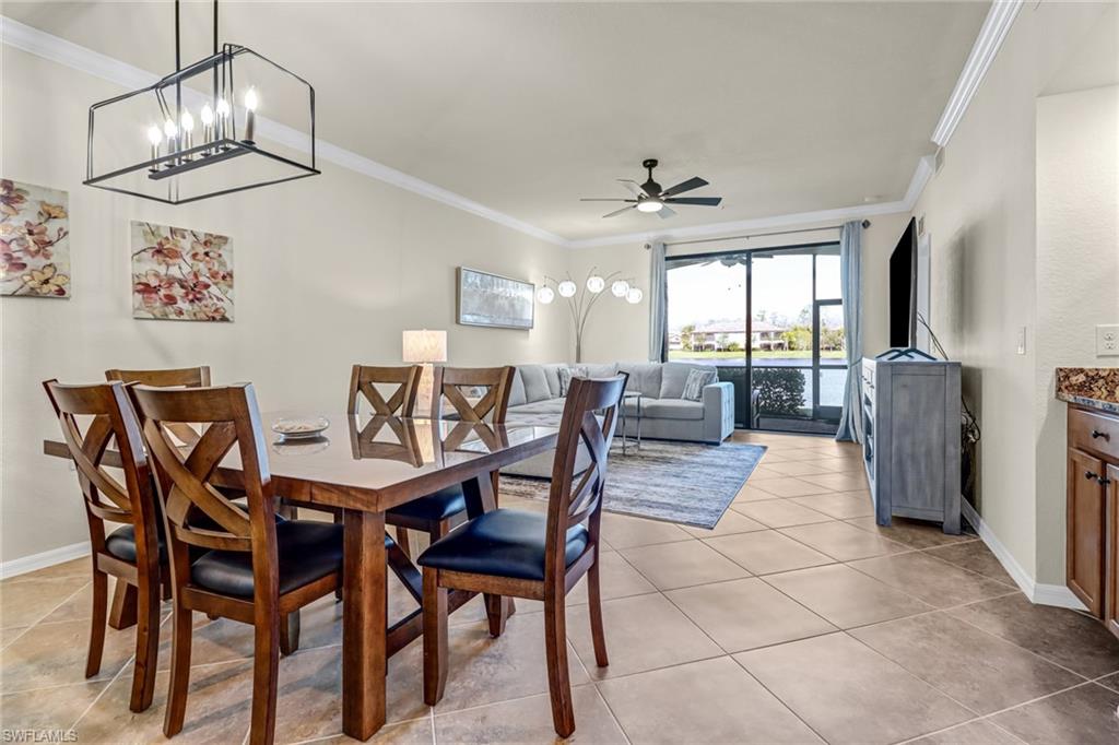 9521 Avellino Way, Unit 2415 Naples, FL 34113 - Photo 29 of 48 a view of a dining room with furniture a chandelier and wooden floor