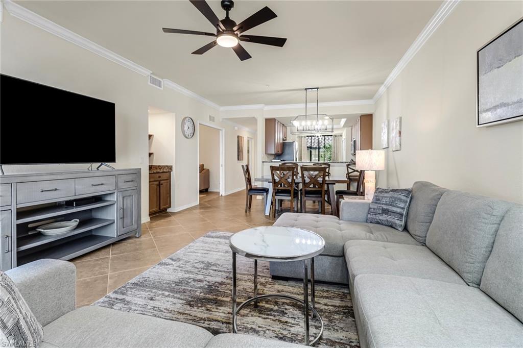 9521 Avellino Way, Unit 2415 Naples, FL 34113 - Photo 31 of 48 a living room with furniture and a flat screen tv