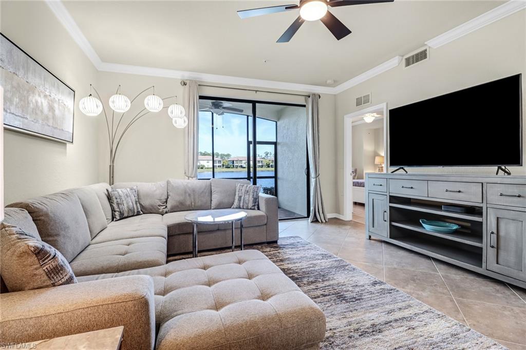 9521 Avellino Way, Unit 2415 Naples, FL 34113 - Photo 34 of 48 a living room with furniture and a flat screen tv