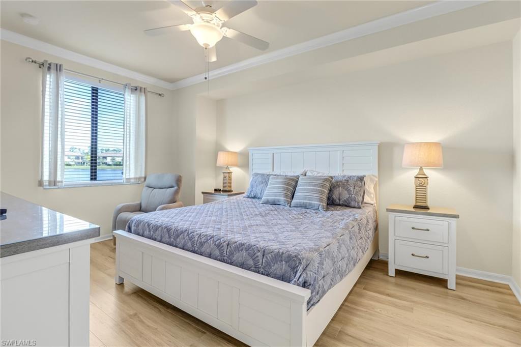 9521 Avellino Way, Unit 2415 Naples, FL 34113 - Photo 35 of 48 a bedroom with a bed and window