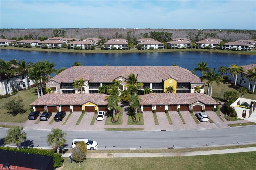 9521 Avellino Way, Unit 2415 Naples, FL 34113 - Photo 45 of 48 an aerial view of house with yard lake and outdoor seating