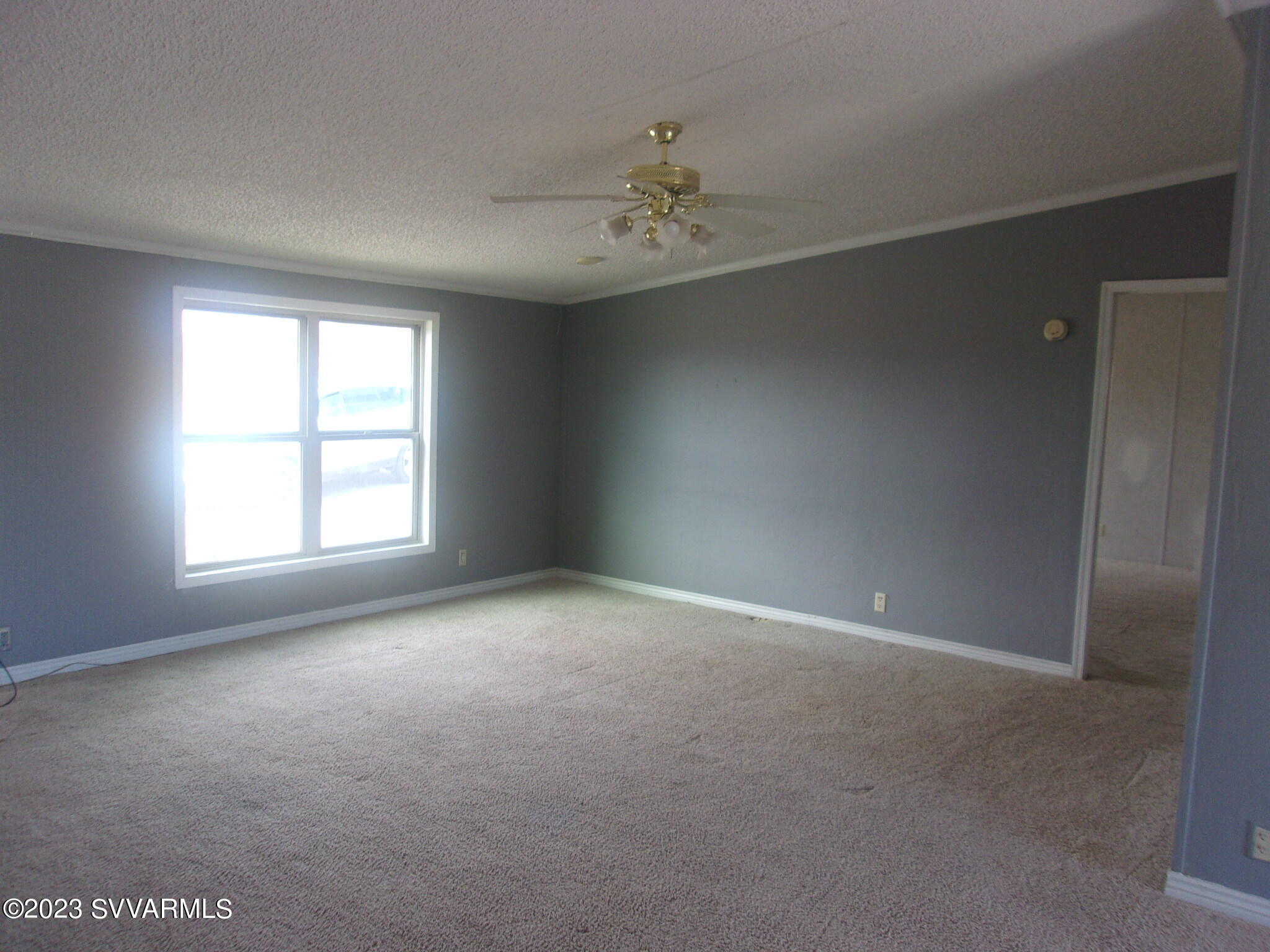 5925 Point Of View Trail Rimrock, AZ 86335 - Photo 5 of 35 an empty room with a chandelier fan and windows