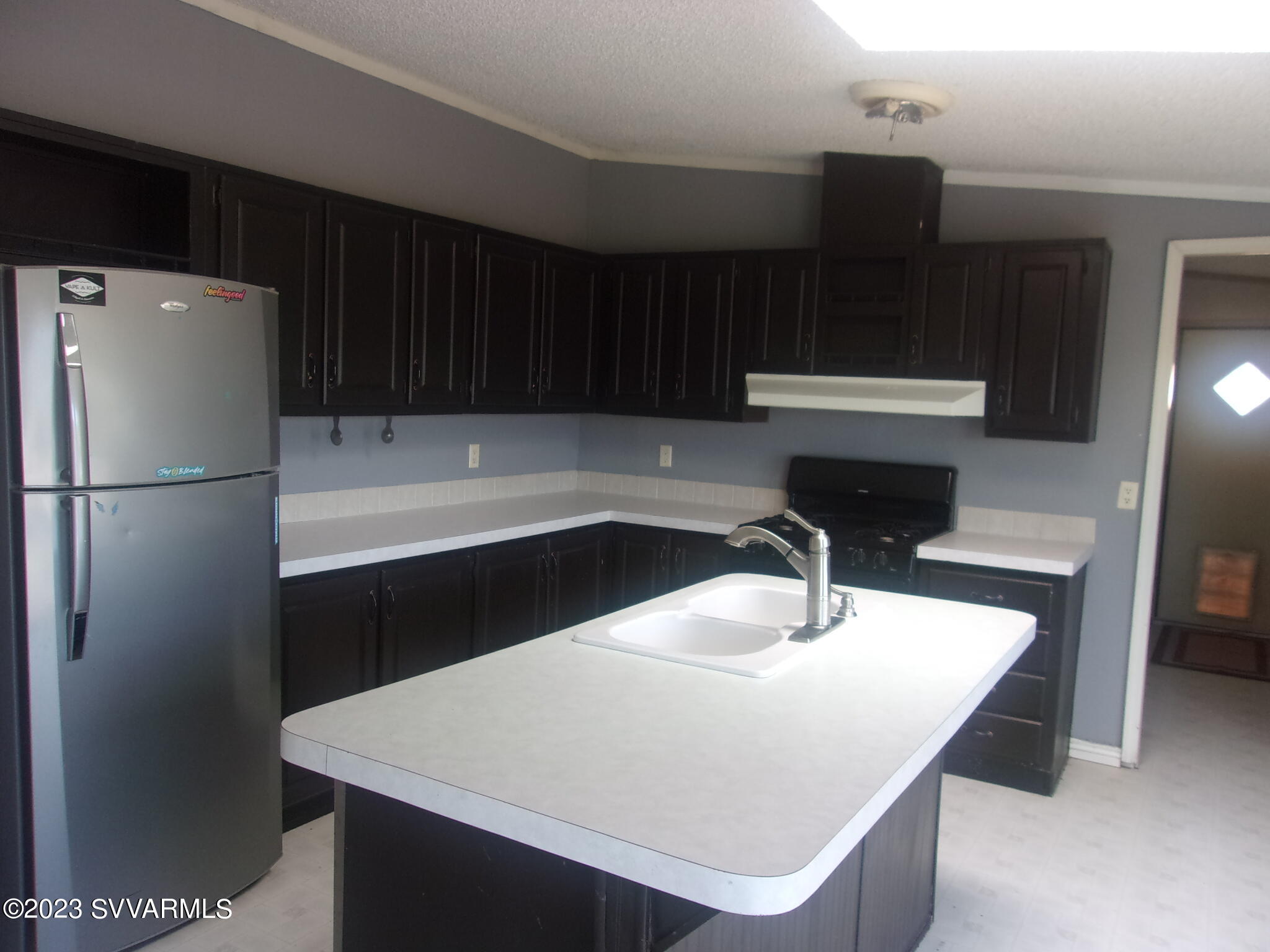 5925 Point Of View Trail Rimrock, AZ 86335 - Photo 6 of 35 a kitchen with a sink a refrigerator and cabinets