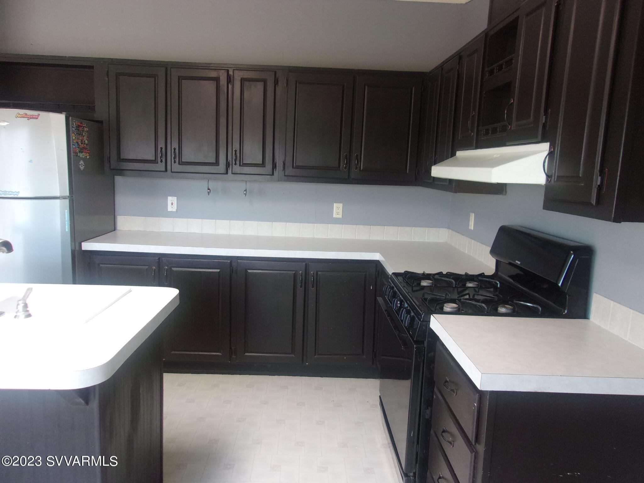 5925 Point Of View Trail Rimrock, AZ 86335 - Photo 8 of 35 a kitchen with a sink a stove a refrigerator and cabinets