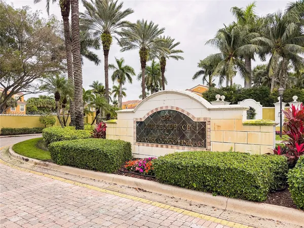 a front view of a house with a garden and trees