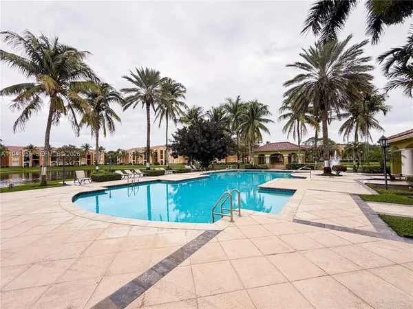 a view of swimming pool with chairs