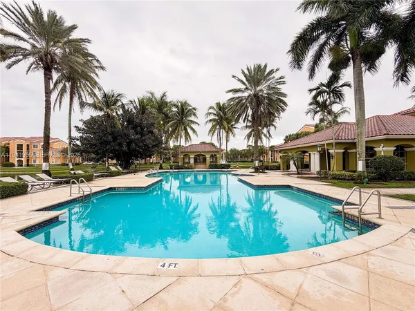 a view of swimming pool with a table and chairs