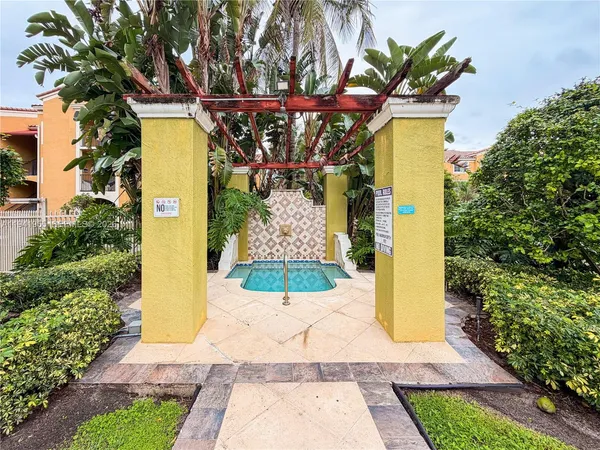 a view of a pathway of a house with a fountain