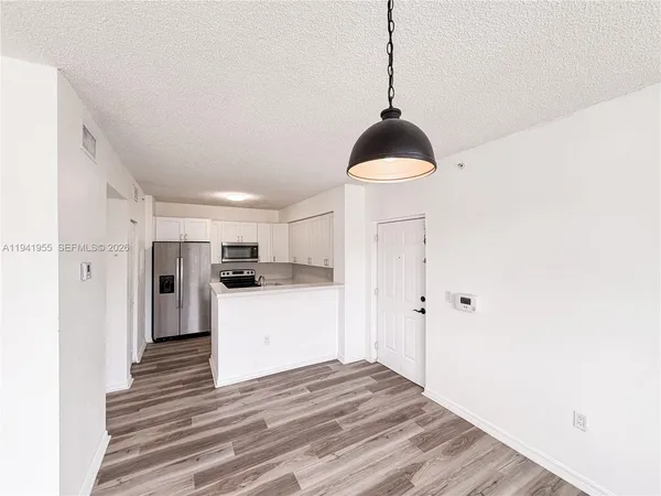 a kitchen view with wooden floor and a window