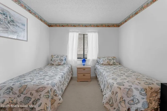 a bedroom with two beds and a window