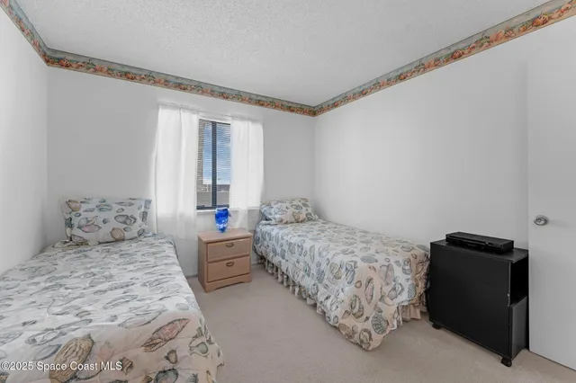 a bedroom with two beds and a window