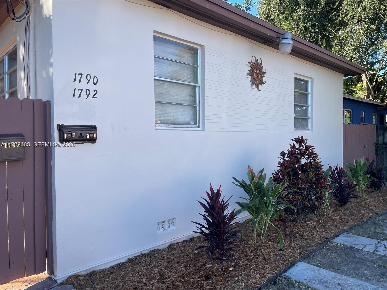 1790 Northwest 19th Street Miami, FL 33125 - Photo 2 of 6 a potted plant sitting in front of a house