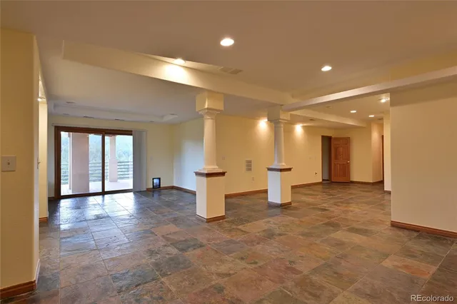 an empty room with windows and pillars in it