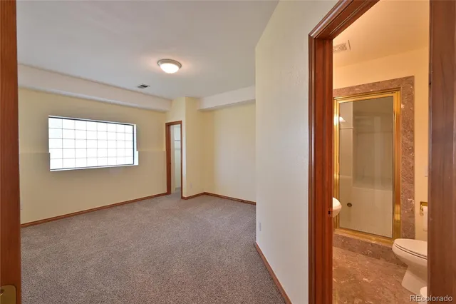 a view of an empty room and a window