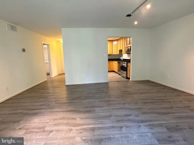 a view of a hallway with wooden floor and a fireplace