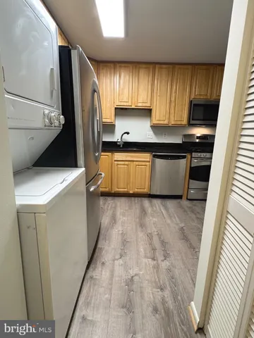 a kitchen with a stove a sink and a refrigerator