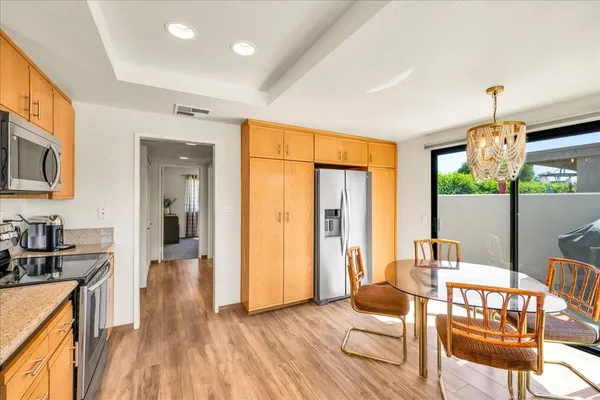 a living room with furniture a flat screen tv and wooden floor