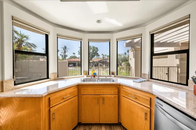 a view of a window and a kitchen with sink