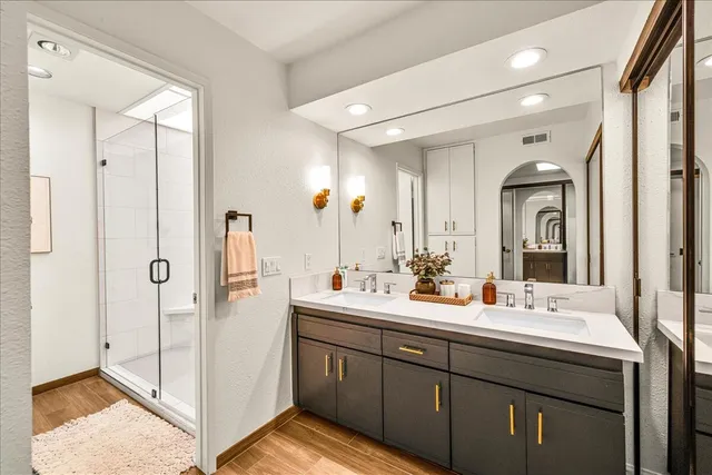 a bathroom with a double vanity sink mirror and double