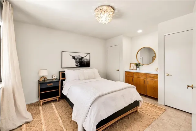 a bedroom with a bed and a dresser