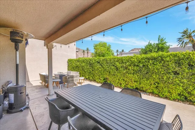 a view of a patio with table and chairs and potted plants