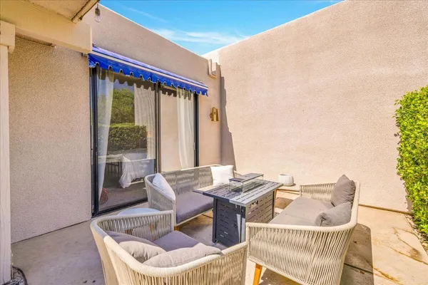 a balcony with furniture and front door