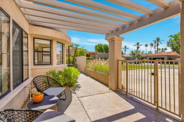 a balcony with furniture and a potted plant