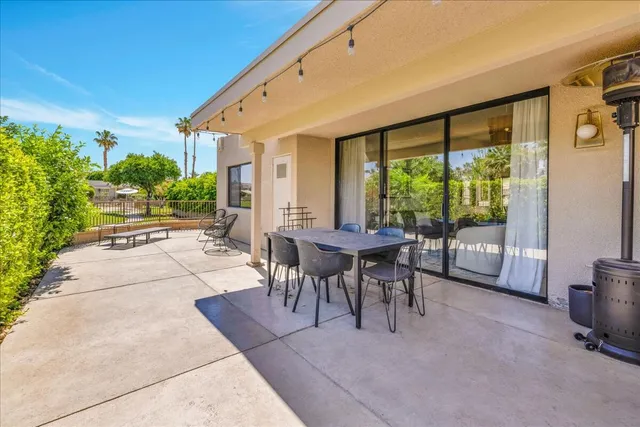 a view of a patio with table and chairs and potted plants