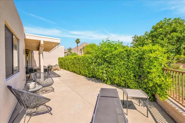 a view of a patio with table and chairs and potted plants