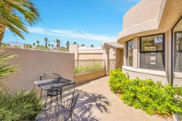 a backyard of a house with yard and outdoor seating