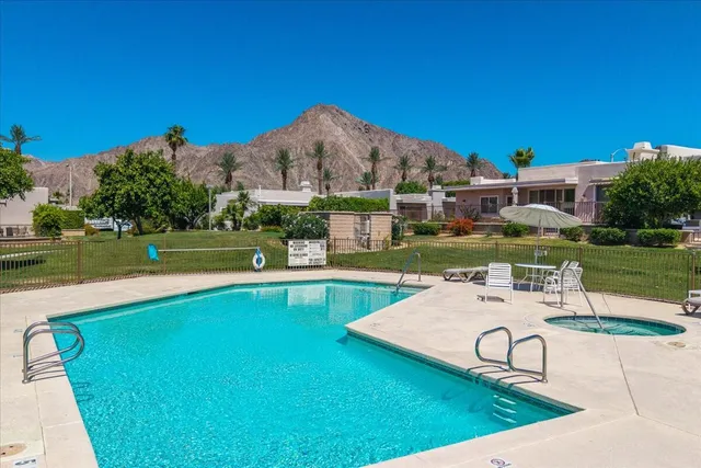 a view of a house with swimming pool and a yard