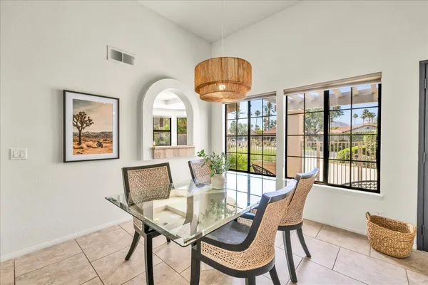 a view of a dining room with furniture window and outside view