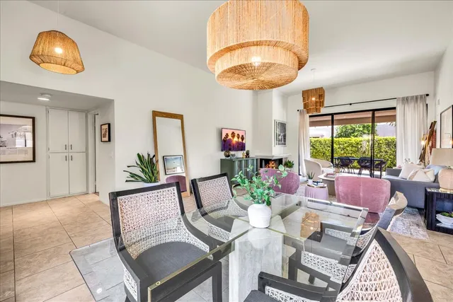 a living room with furniture a chandelier and a large window