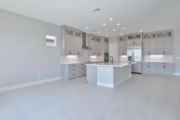 a large white kitchen with a white countertops and cabinets
