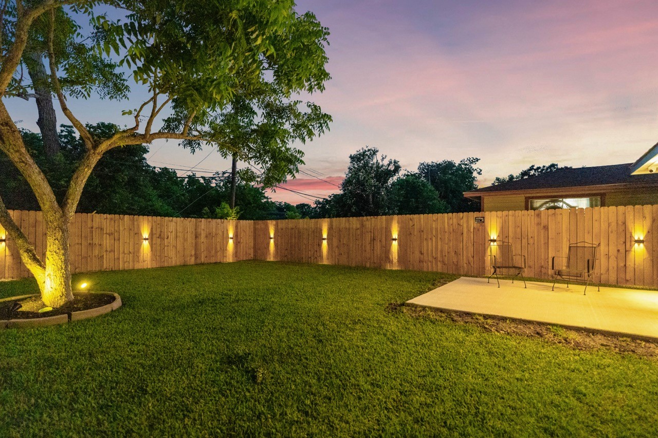 3138 Sunbeam Street Houston, TX 77051 - Photo 48 of 50 Beautifully lit landscaping and expansive green space create an unforgettable outdoor experience day or night.