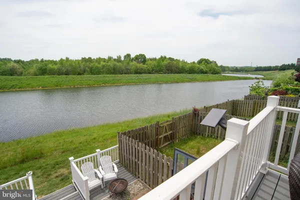 a view of a lake with houses in the back