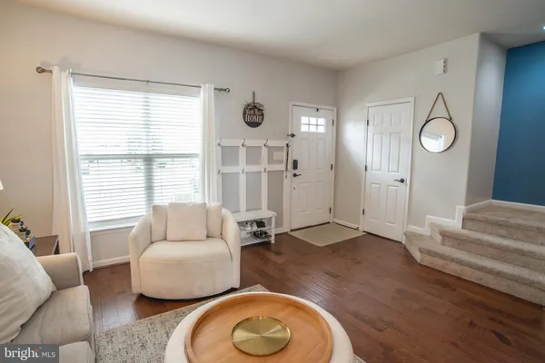 a living room with furniture wooden floor and a chandelier