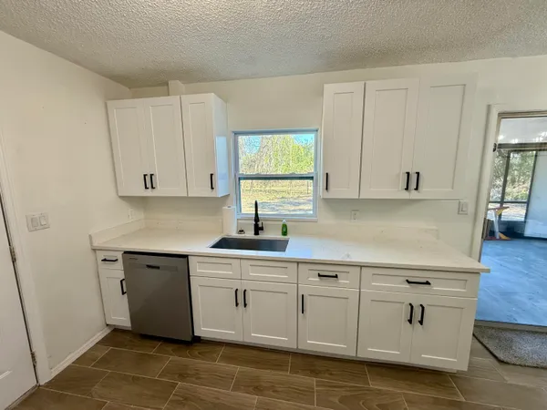 a kitchen with white cabinets