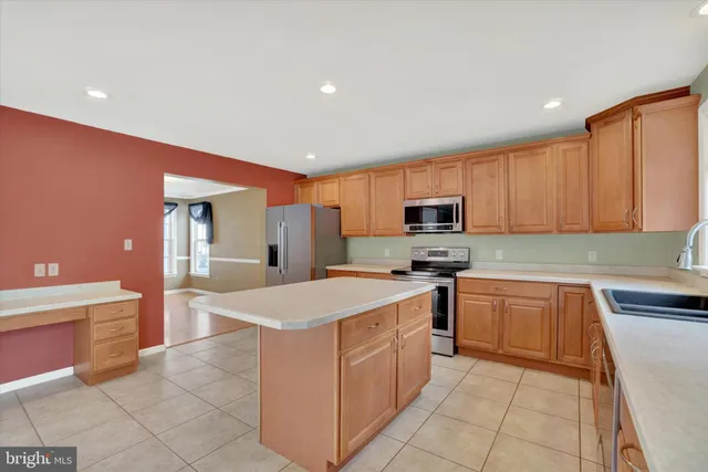 a kitchen with stainless steel appliances granite countertop a refrigerator stove microwave and sink