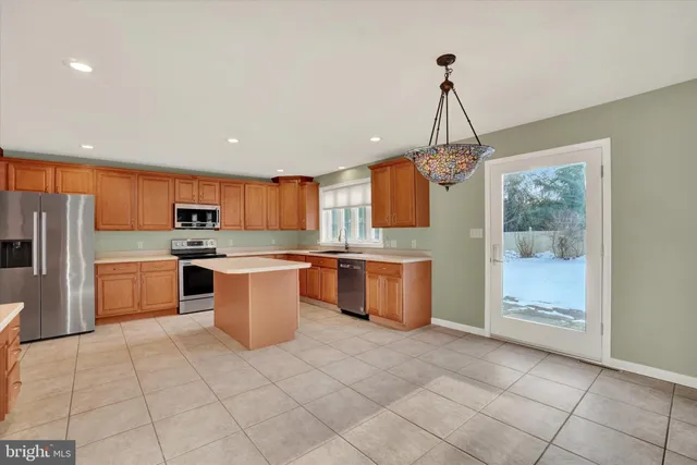 a view of a livingroom with a fireplace and window