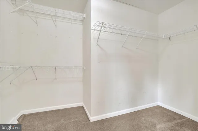 a spacious bathroom with a double vanity sink a mirror and a bathtub