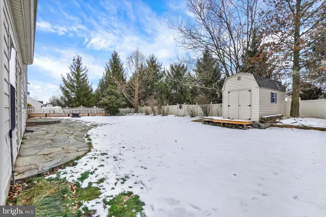 a view of a house with a snow in the yard