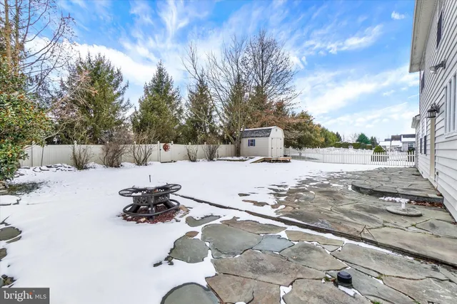 a view of a white house with a snow on the road