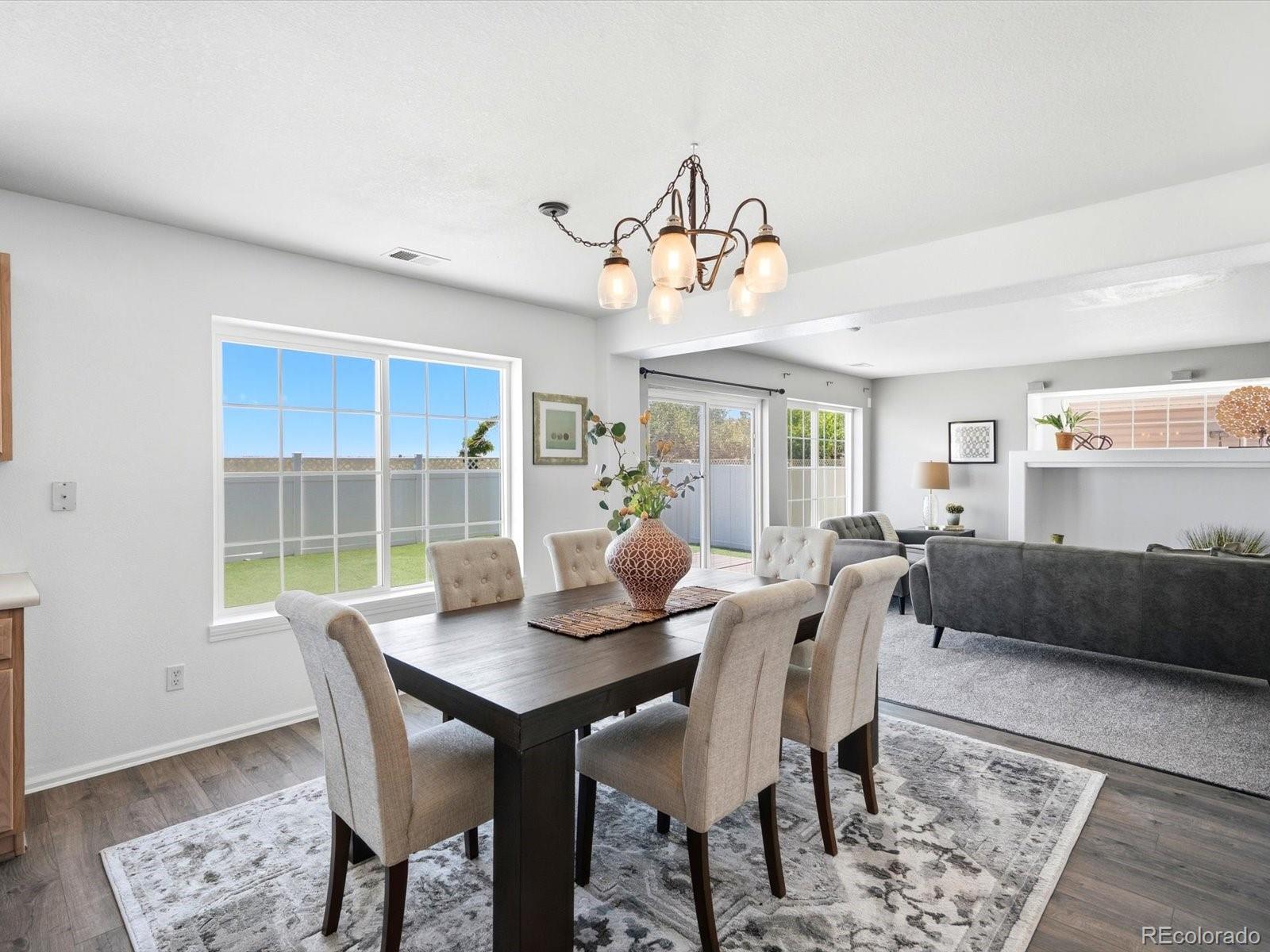 5444 Perth Court Denver, CO 80249 - Photo 12 of 46 a view of a dining room with furniture window and wooden floor
