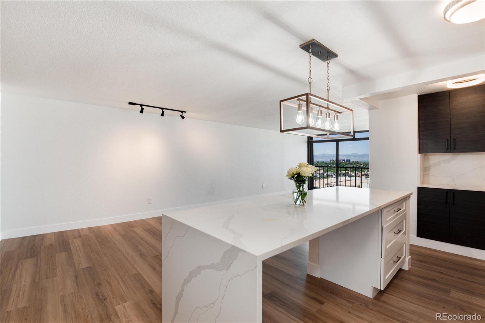 2 Adams Street, Unit 1504 Denver, CO 80206 - Photo 13 of 43 a room with view of wooden floor and utility room