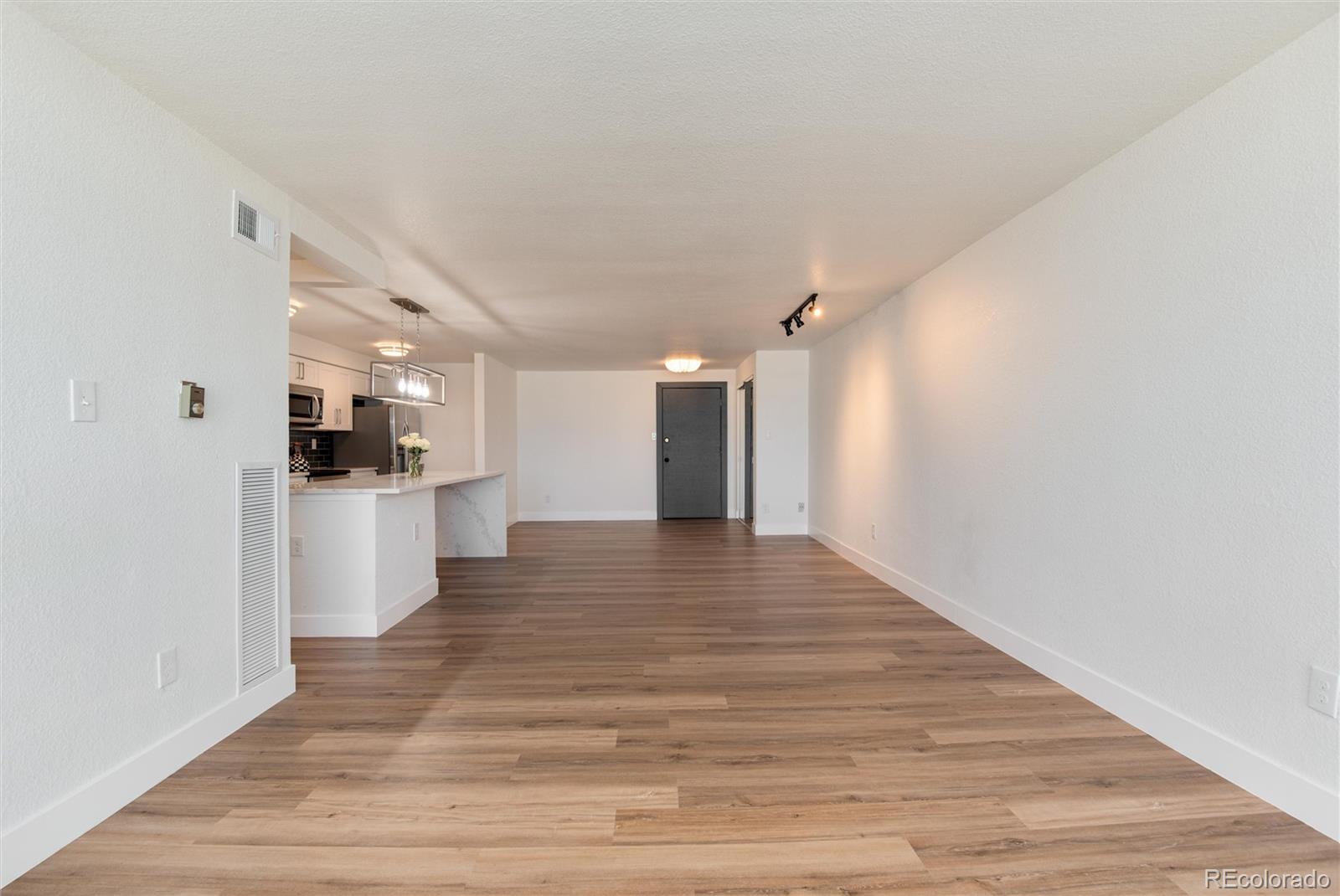 2 Adams Street, Unit 1504 Denver, CO 80206 - Photo 18 of 43 a view of a kitchen with a sink and a refrigerator