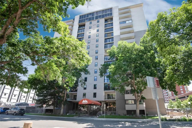 front view of a building with a tree